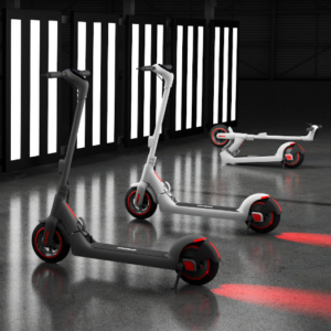 Bremer R-Series electric scooters in grey and white displayed in a modern showroom with dynamic lighting