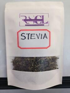 A white package of stevia leaves with a see-through window labeled 'STEVIA' in red and black font, and the logo 'RSCL' at the top.