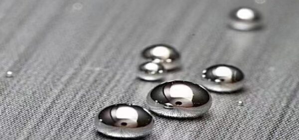 Close-up view of high-purity Silver Liquid Mercury droplets on a sleek surface, showcasing the product's purity and consistency.