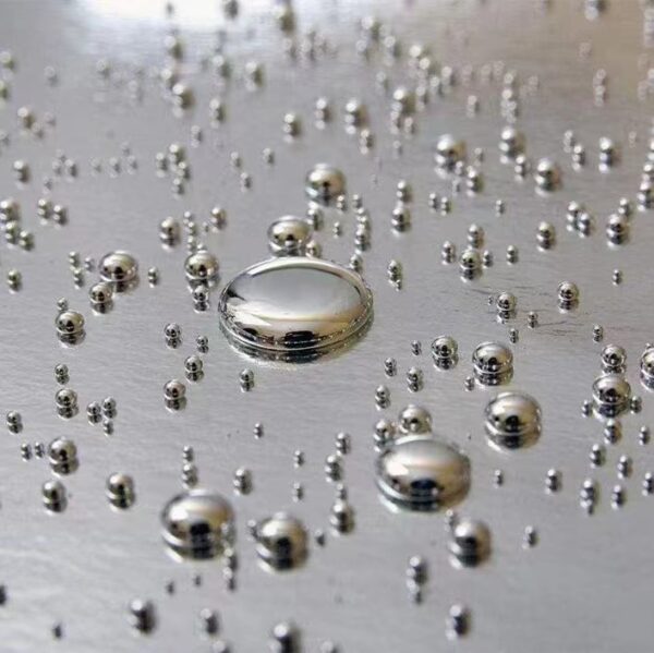 Close-up view of high-purity Silver Liquid Mercury droplets on a sleek surface, showcasing the product's purity and consistency.