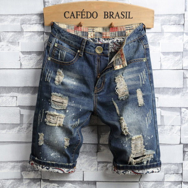 Artfully distressed denim shorts with a cuffed hem and decorative inner waistband on display.