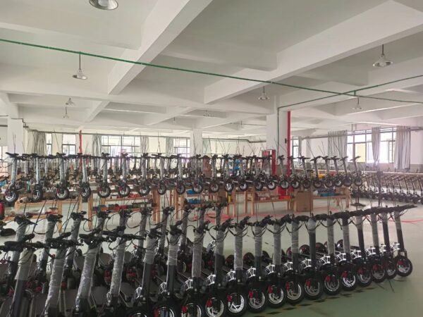Warehouse filled with rows of J11 Nairobi e-scooters ready for distribution.